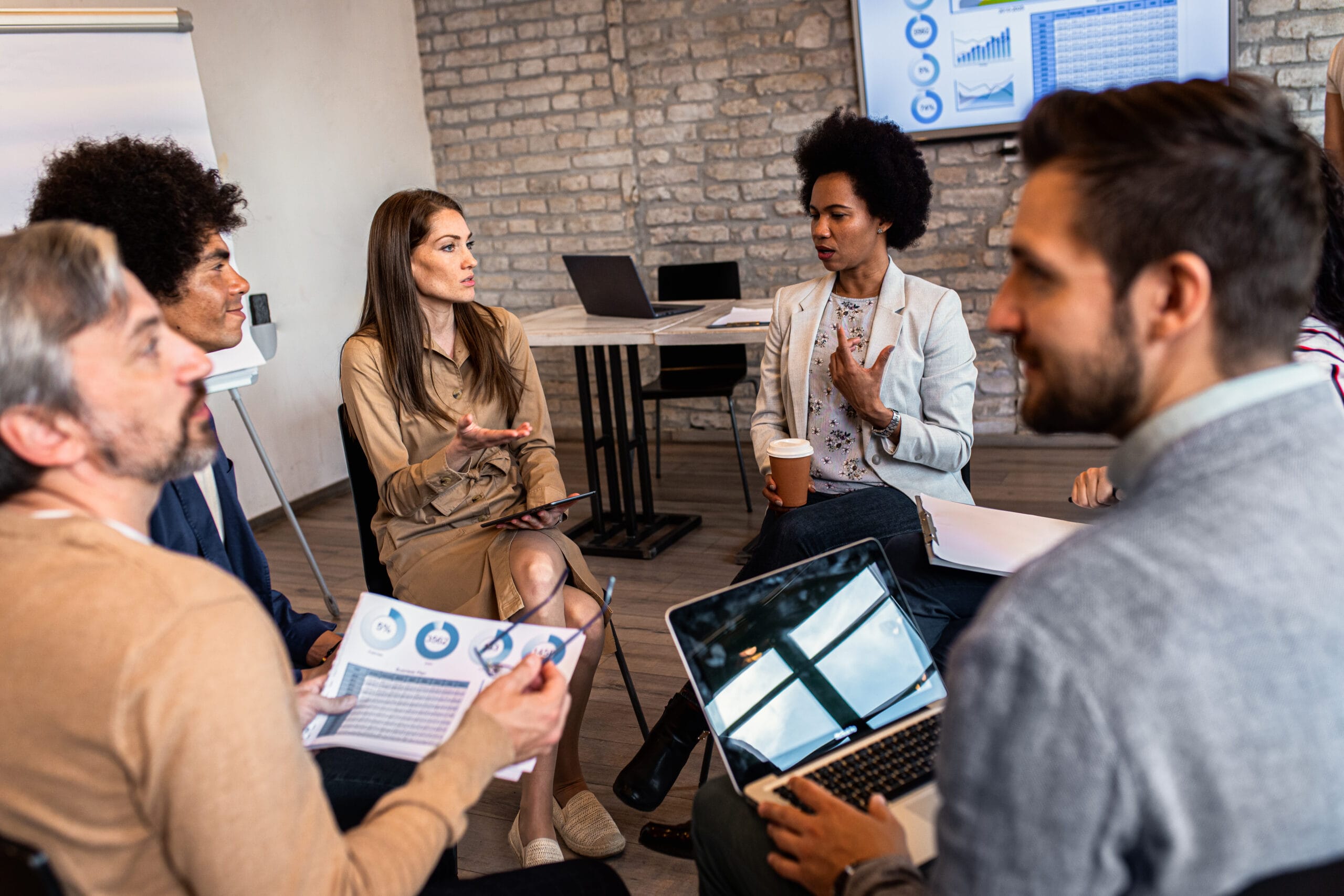 Group of diverse group of business people having a meeting while Group of diverse group of business people having a meeting while